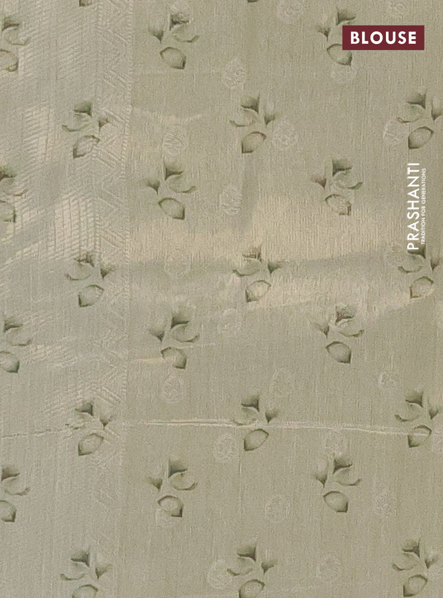 Tissue saree pista green with allover zari weaves and floral digital printed border