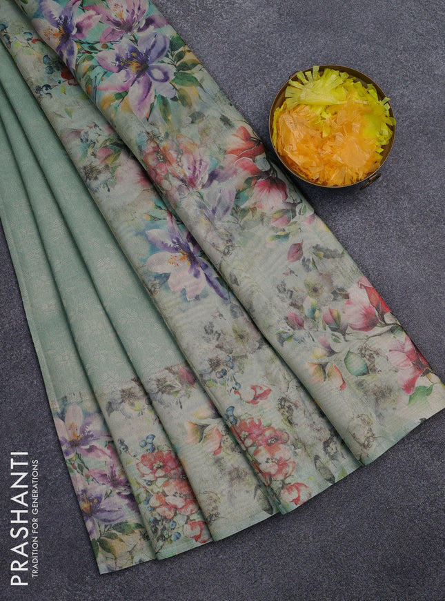 Tissue saree teal green shade with allover zari weaves and floral digital printed border