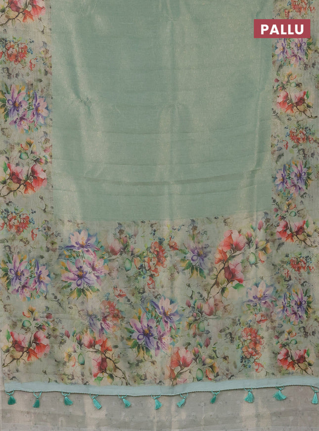 Tissue saree teal green shade with allover zari weaves and floral digital printed border