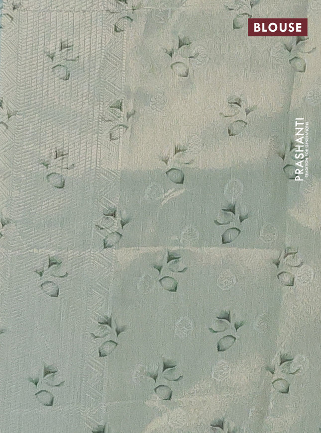 Tissue saree teal green shade with allover zari weaves and floral digital printed border