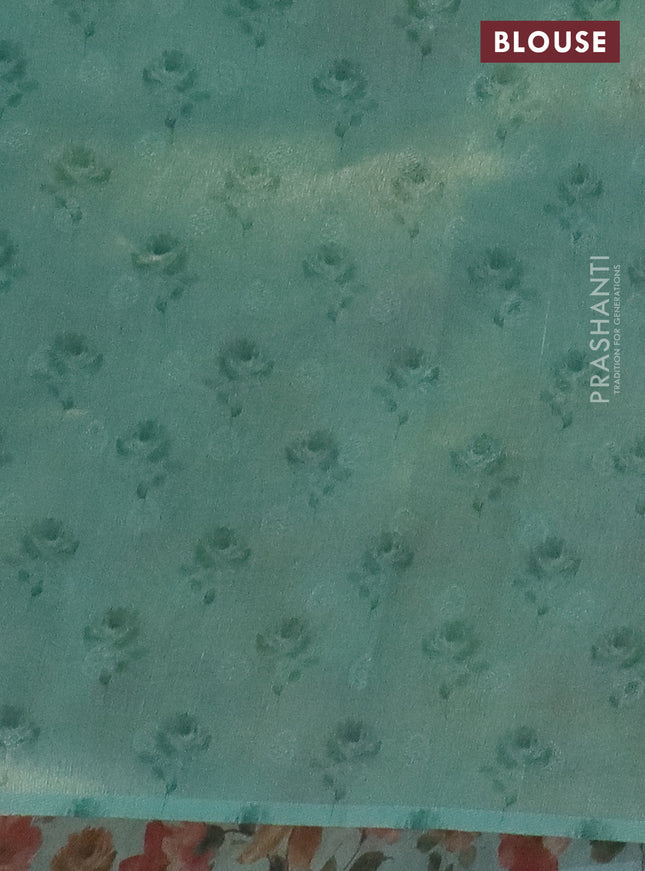 Tissue saree pastel blue with allover zari weaves and floral digital printed border