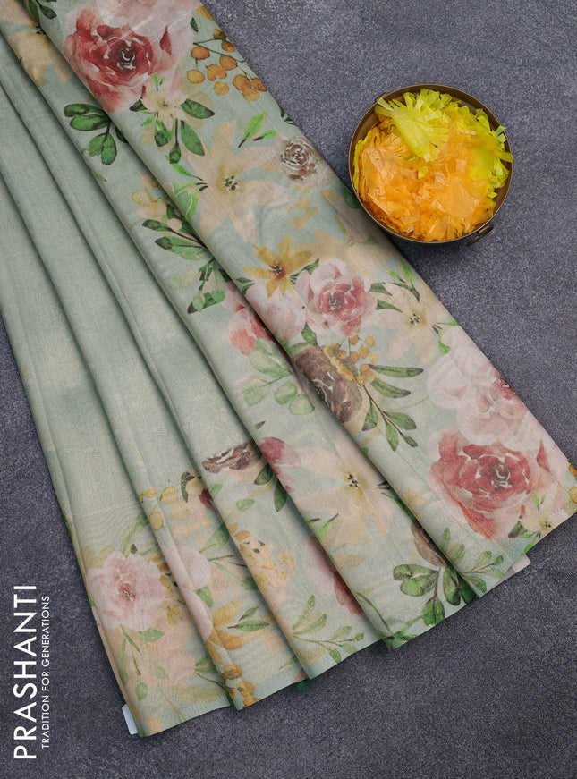 Tissue saree pastel green with allover zari weaves and floral digital printed border