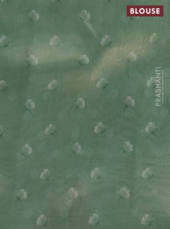 Tissue saree pastel green with allover zari weaves and floral digital printed border