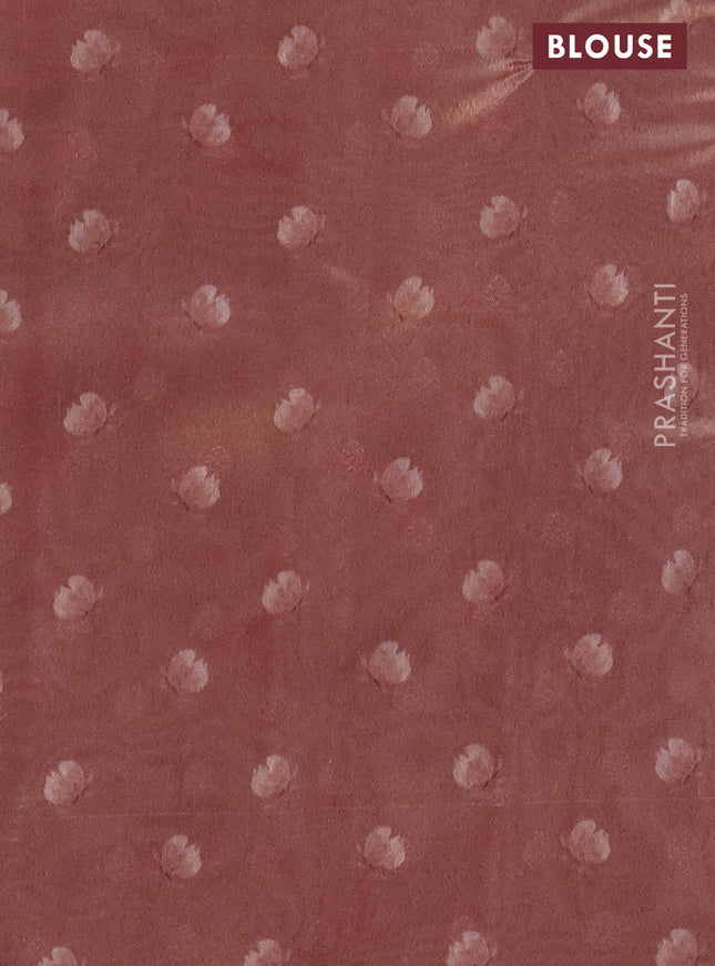 Tissue saree pastel peach orange with allover zari weaves and floral digital printed border