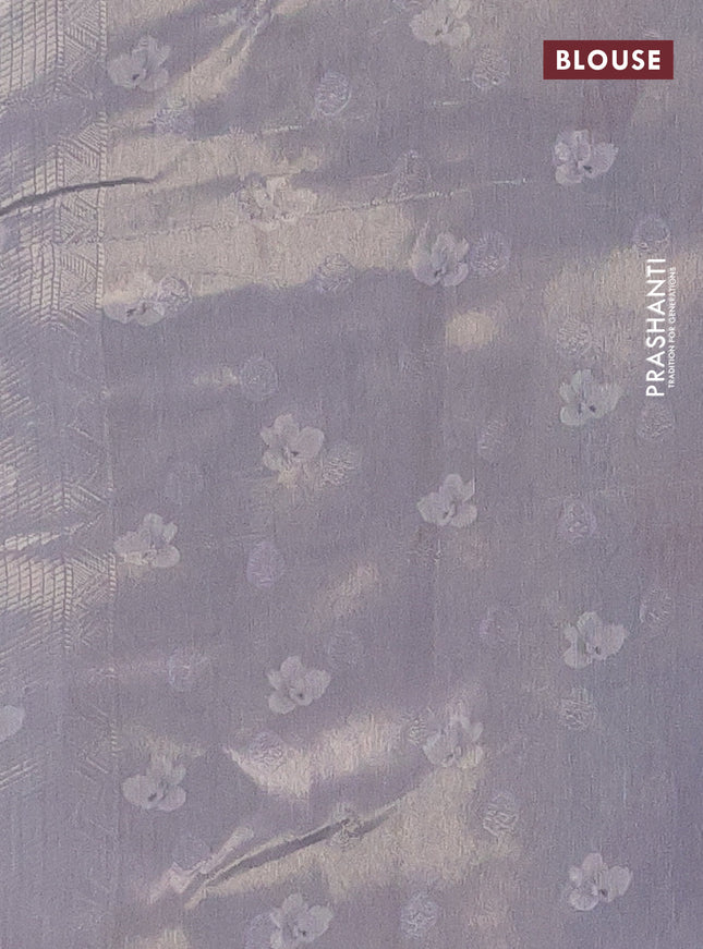 Tissue saree sandal and pastel blue with allover zari weaves and floral digital printed border