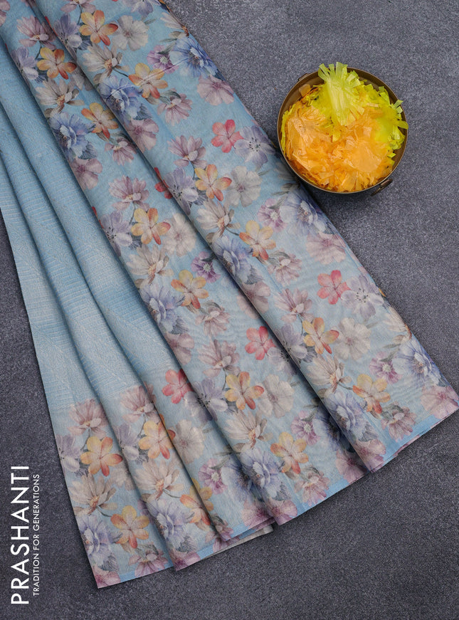 Tissue saree light blue with allover zari weaves and floral digital printed border