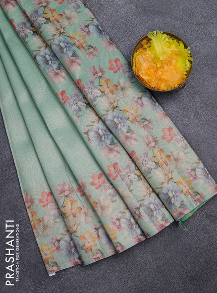 Tissue saree teal green shade with allover zari weaves and floral digital printed border