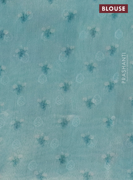 Tissue saree teal blue with allover zari weaves and floral digital printed border