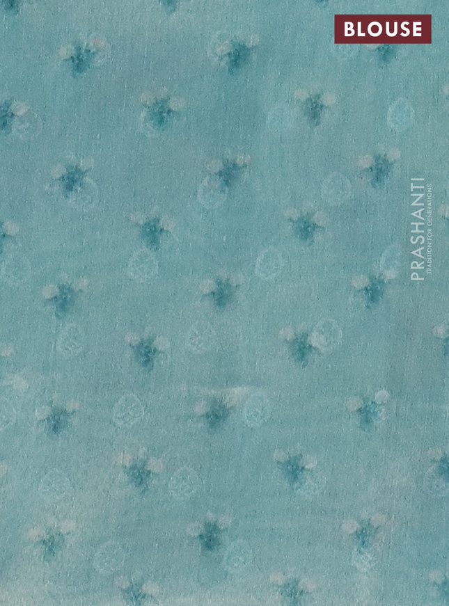 Tissue saree teal blue with allover zari weaves and floral digital printed border