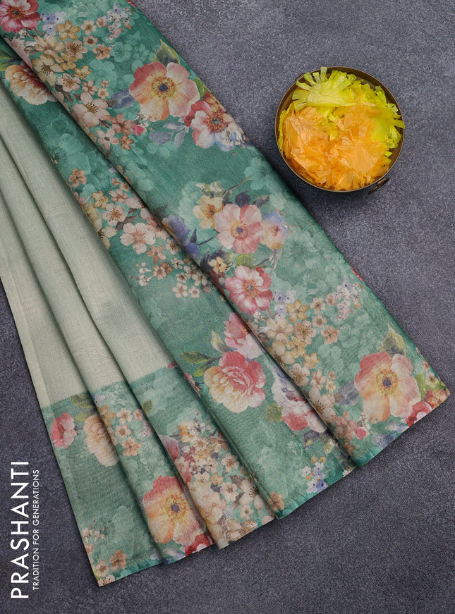 Tissue saree pastel green and green with allover zari weaves and floral digital printed border