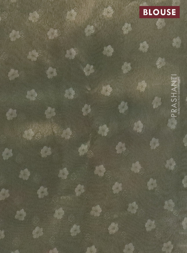 Tissue saree pastel pista green and green shade with allover zari weaves and floral digital printed border