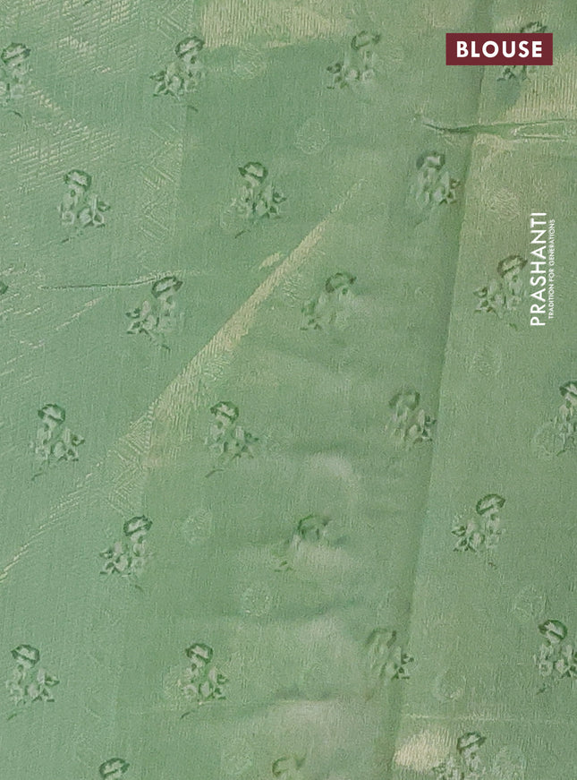 Tissue saree pista green with allover zari weaves and digital printed border