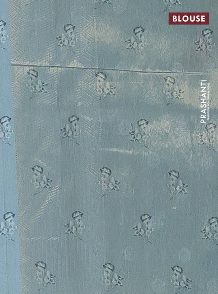 Tissue saree pastel green with allover zari weaves and digital printed border