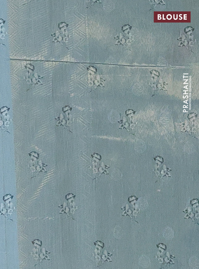 Tissue saree pastel green with allover zari weaves and digital printed border