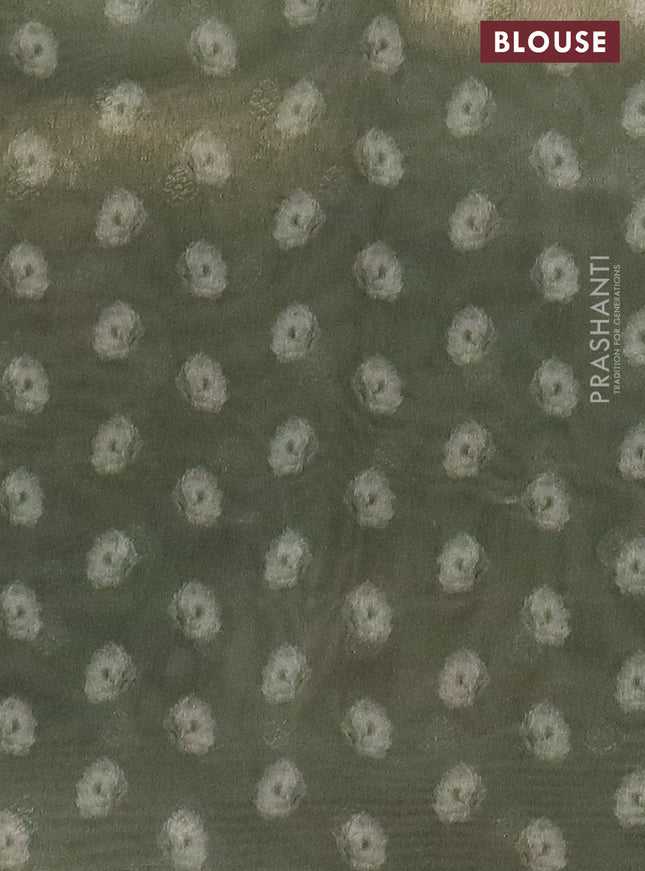 Tissue saree cream and sap green with allover zari weaves and floral digital printed border