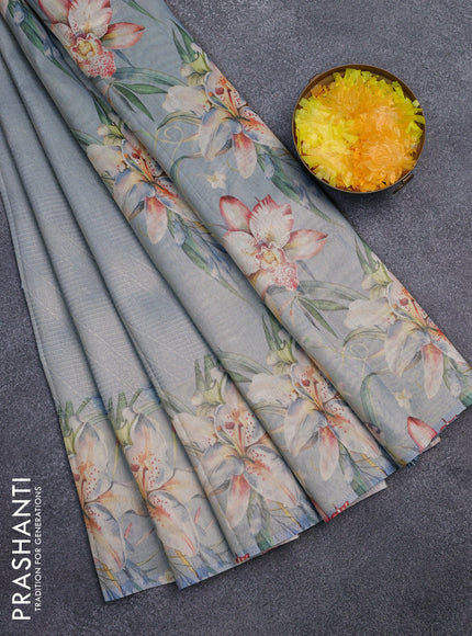 Tissue saree pastel blue with allover zari weaves and floral digital printed border