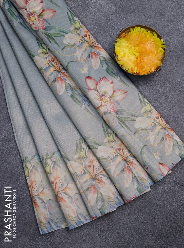 Tissue saree pastel blue with allover zari weaves and floral digital printed border
