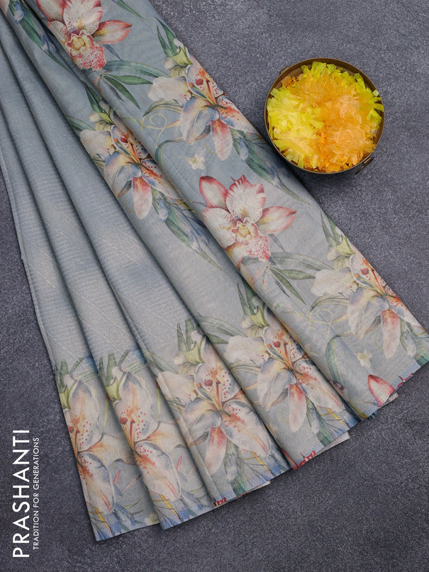 Tissue saree pastel blue with allover zari weaves and floral digital printed border