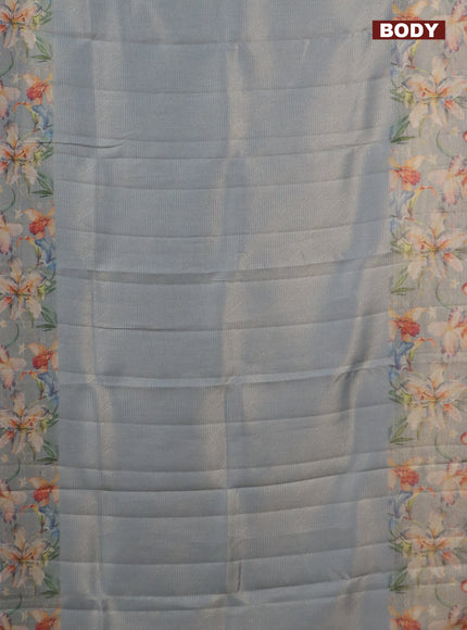 Tissue saree pastel blue with allover zari weaves and floral digital printed border