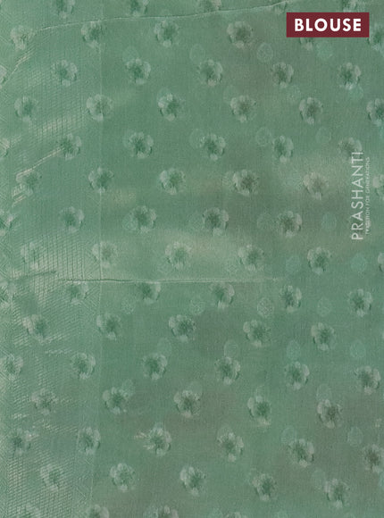 Tissue saree pista green with allover zari weaves and floral digital printed border