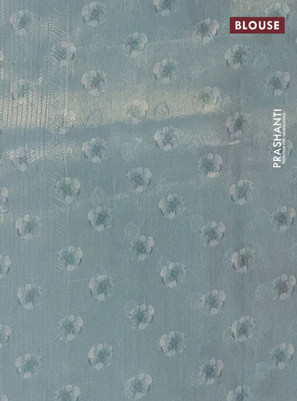 Tissue saree pastel green with allover zari weaves and floral digital printed border