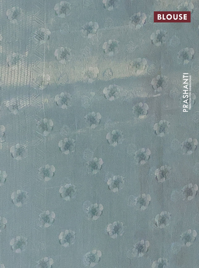 Tissue saree pastel green with allover zari weaves and floral digital printed border