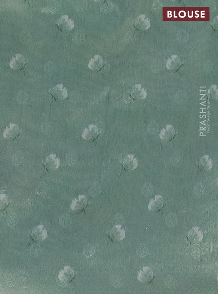 Tissue saree pastel green with allover zari weaves and floral digital printed border