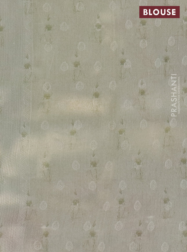 Tissue saree pista green with allover zari weaves and floral digital printed border