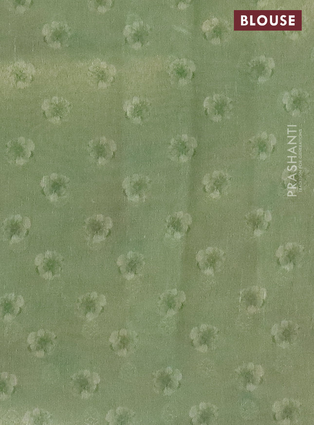 Tissue saree pista green with allover zari weaves and floral digital printed border