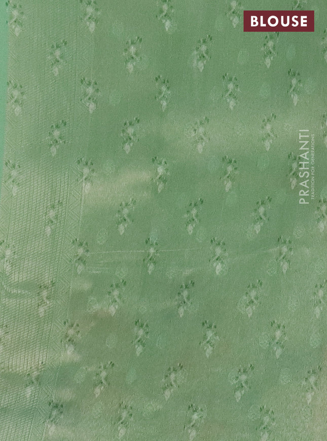 Tissue saree pista green with allover zari weaves and floral digital printed border