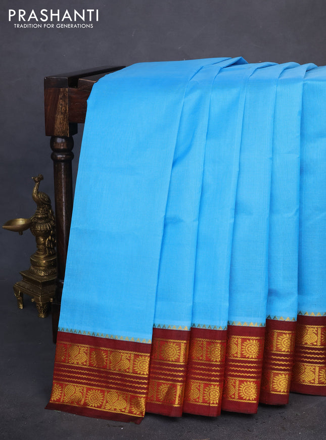 Silk cotton saree light blue and maroon with plain body and zari woven korvai border