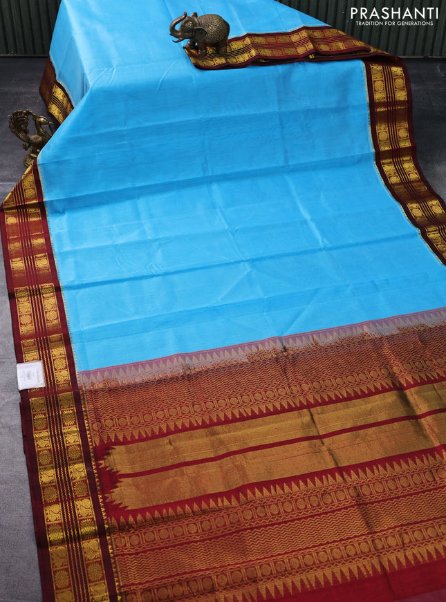 Silk cotton saree light blue and maroon with plain body and zari woven korvai border