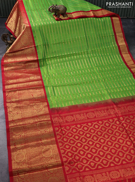 Kuppadam silk cotton saree green and red with allover zari woven stripes pattern and long zari woven border