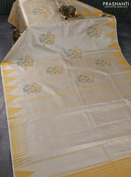 Tissue saree mustard yellow with embroidery work buttas and temple design zari border