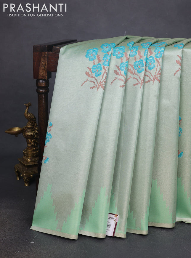 Tissue saree pastel green with embroidery work buttas and temple design zari border