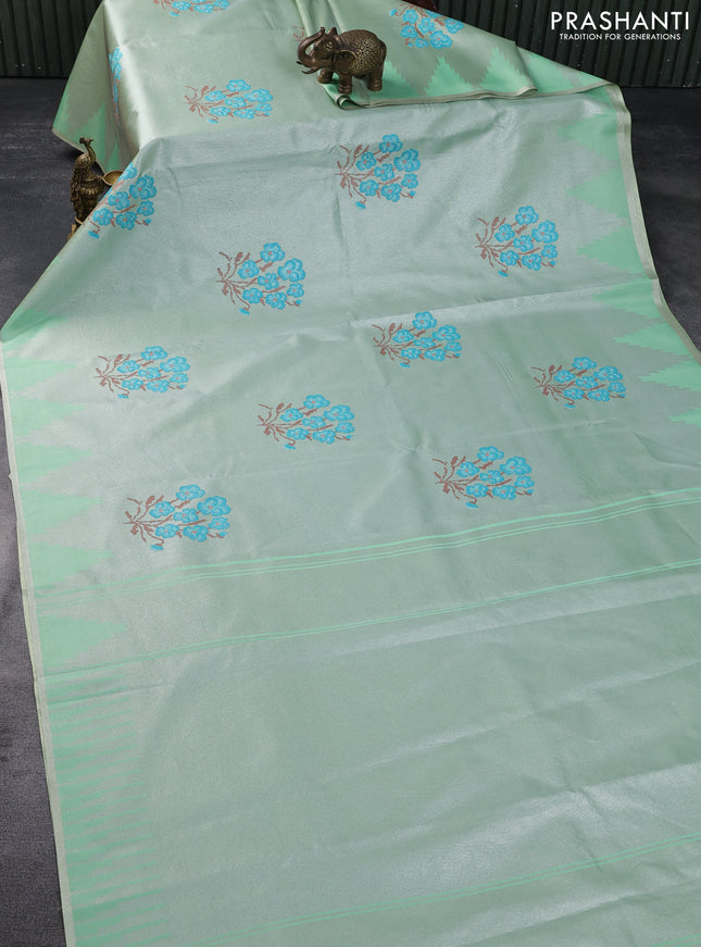 Tissue saree pastel green with embroidery work buttas and temple design zari border