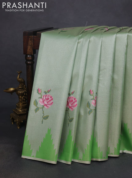 Tissue saree green with embroidery work buttas and temple design zari border