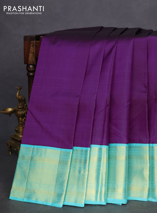 Pure kanchipuram silk saree deep purple and teal shade with plain body and zari woven korvai border