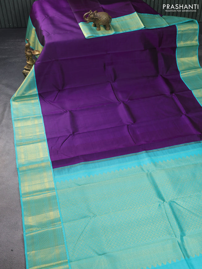 Pure kanchipuram silk saree deep purple and teal shade with plain body and zari woven korvai border