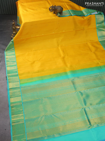 Pure kanchipuram silk saree yellow and dual shade of teal with zari woven paisley buttas and zari woven korvai border