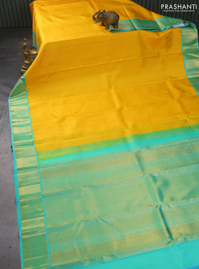 Pure kanchipuram silk saree yellow and dual shade of teal with zari woven paisley buttas and zari woven korvai border