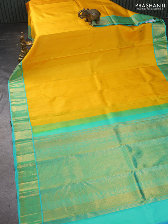 Pure kanchipuram silk saree yellow and dual shade of teal with zari woven paisley buttas and zari woven korvai border