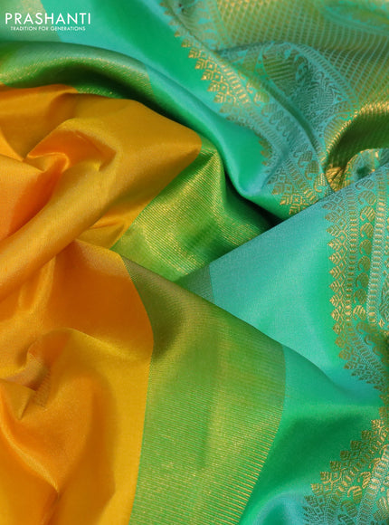 Pure kanchipuram silk saree yellow and dual shade of teal with zari woven paisley buttas and zari woven korvai border