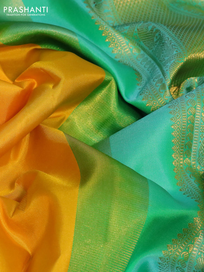 Pure kanchipuram silk saree yellow and dual shade of teal with zari woven paisley buttas and zari woven korvai border