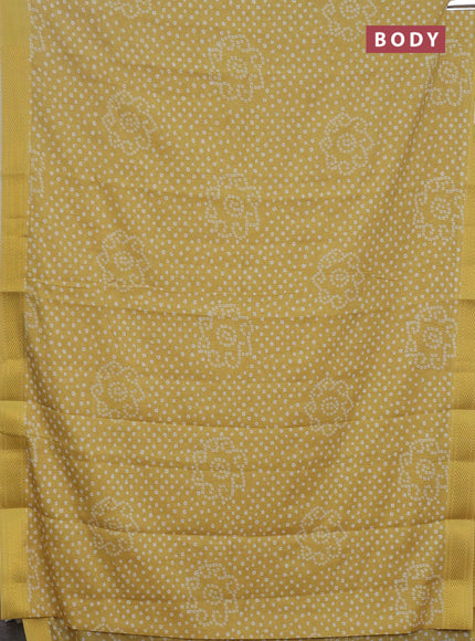 Spun cotton saree yellow with allover bandhani prints and zari woven border