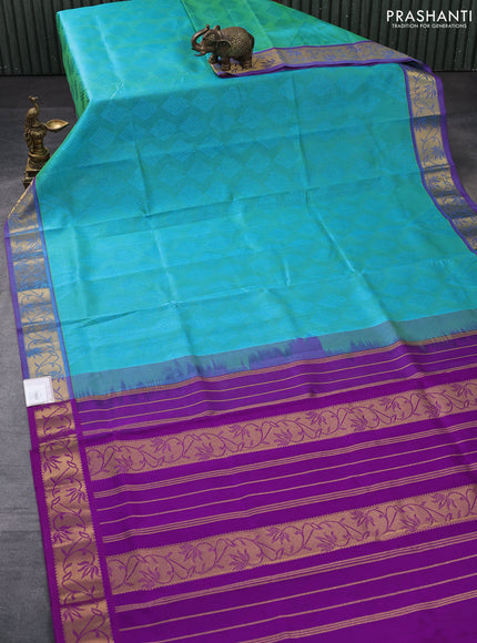 Silk cotton saree dual shade of teal bluish green and purple with allover self emboss jacquard and rich zari woven border