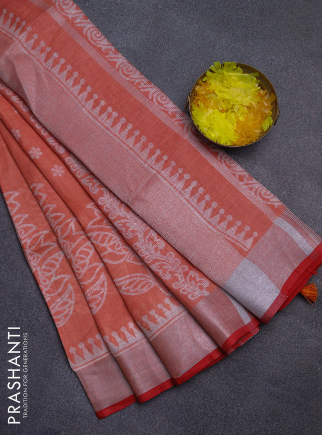 Pure linen saree pale orange and red with allover prints and silver zari woven border
