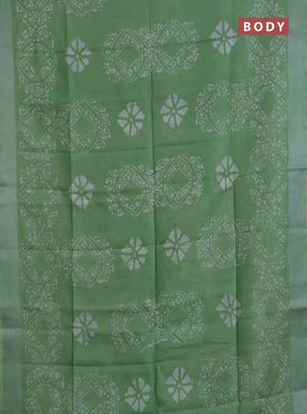Pure linen saree teal green shade with allover batik prints and silver zari woven border