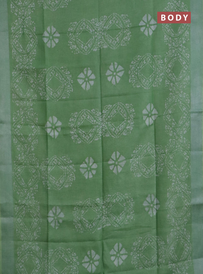 Pure linen saree teal green shade with allover batik prints and silver zari woven border