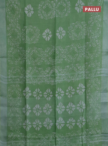 Pure linen saree teal green shade with allover batik prints and silver zari woven border